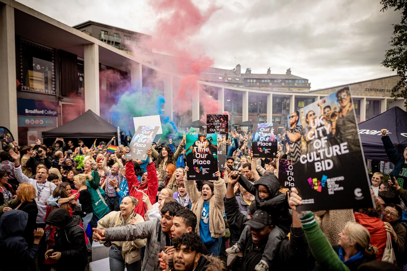 A group of people holding signs

Description automatically generated