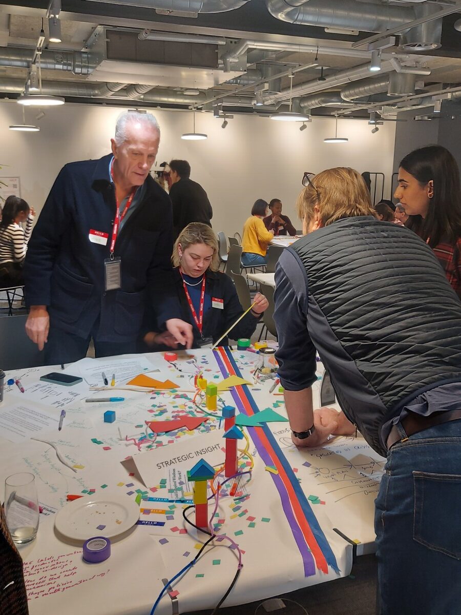 A busy room with practitioners of different ages and levels of seniority at Multigenerational Places: Practice. 